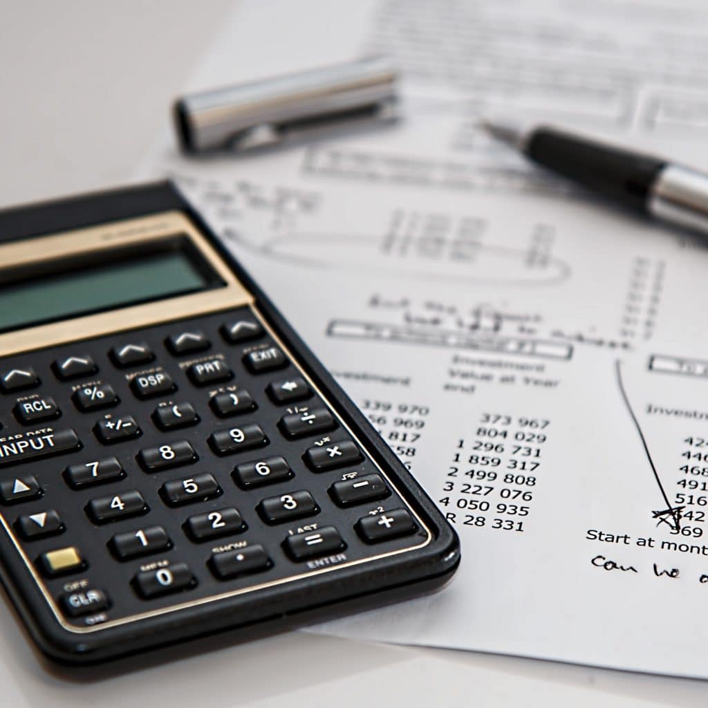 Calculator, pen and financial documents on a table, representing an accountant in Koroit, Victoria